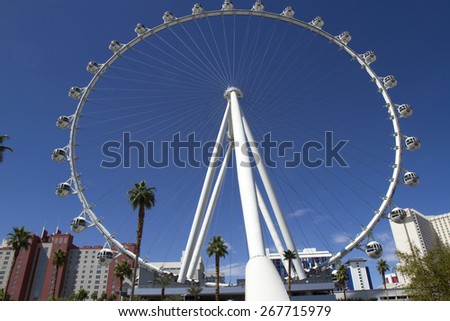 Las Vegas, NV, USA - March 24, 2015 : High Roller ferris wheel on the strip in Las Vegas showing strip hotels against blue sky