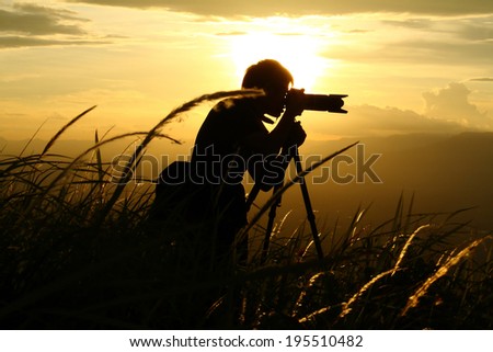 Silhouette of a young photographer during the sunset.