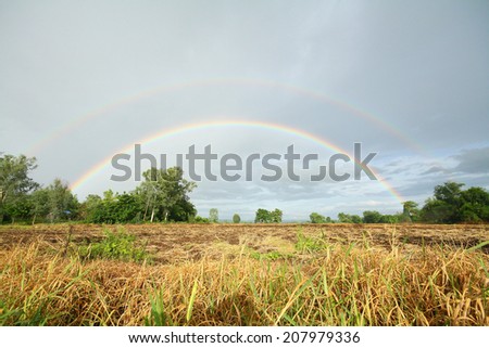 Double rainbows after the rain In the meadow at Thailand