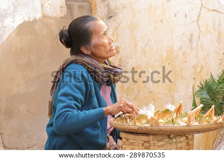 The old woman selling a local products at Shwezigon Pagoda at Bagan in Myanmar on Feb 01, 2014 : Shwezigon Pagoda there is a market for selling many products to the people who come to worship