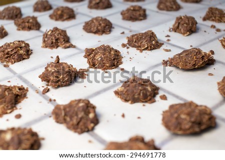 Many no baked cookies placed separately in rows with several messy crumbs