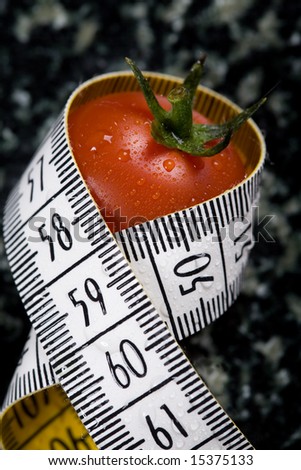 measuring tape wrapped around tomato