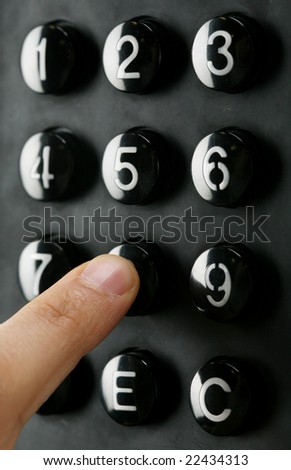 A finger entering a code into the keypad