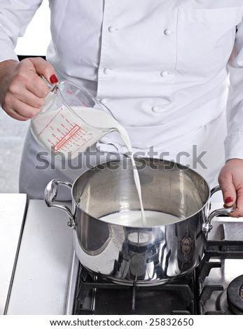 preparing cake pouring milk in to a pan