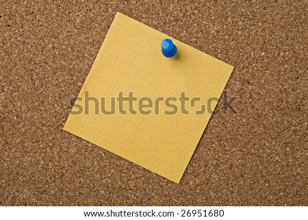 yellow note paper pinned on a cork  board