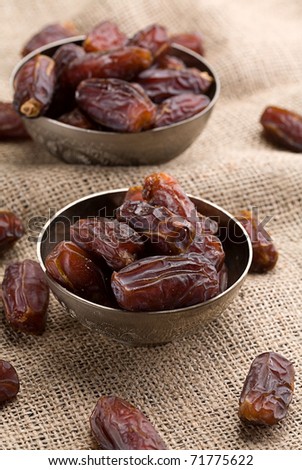 date in little bowl on a natural background