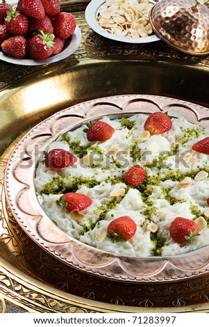 a traditional turkish  sweet made from sheets of dough made of starch soaked in milky syrup, filled with nuts and flavored with rose water