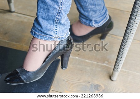 Legs slender girl in black sandals