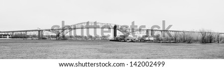 Panoramic black and white photo of the blue water bridge between Port Huron Michigan and Sarnia Ontario.