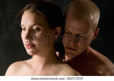 man holding woman from behind closeup head and shoulders shot