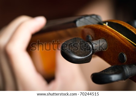 close-up of fingers on a violin string