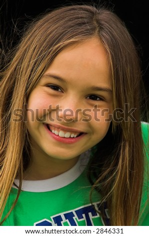 A big smile from a cute little girl.