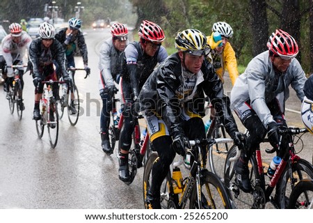 SANTA CRUZ, CA - February 16, 2009: Bicyclers in the Tour of California 2009 race riding through a rainstorm in the Santa Cruz Mountains on February 16, 2009.