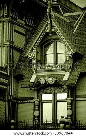 Green monochrome of an old victorian mansion.
