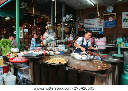 Bangkok, Thailand- June 10, 2015:  Food stall in Chatuchak weekend market. A men busy preparing food for customers. Braised Beef Noodle Soup and stewed pork rice are the famous food in Thailand.
