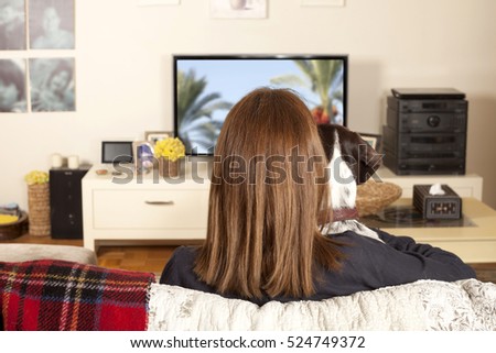 girl watching tv with dog
