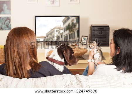 family watching tv with pets