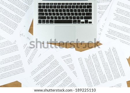 laptop with paper scattered