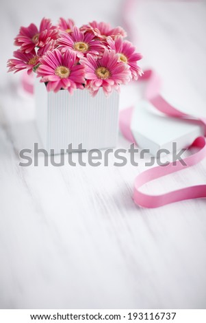 the image of flowers in white box