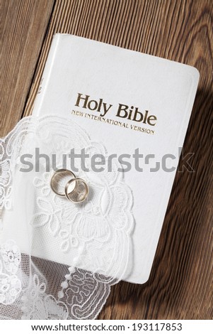 the image of Bible and wedding rings