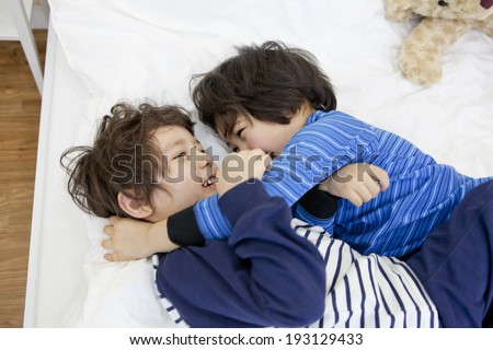 Cute Korean kids playing in bed