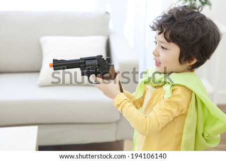 the image of cute Asian boy with toy gun