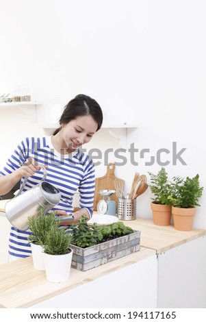 the image of Asian woman watering plants