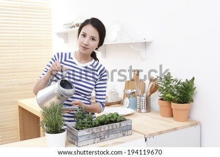 the image of asian woman watering plants