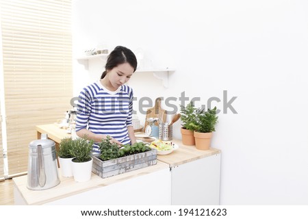 the image of Asian woman watering plants