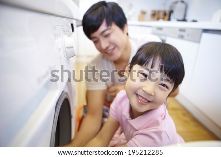 the image of a happy Asian family doing laundry