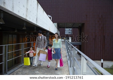 the image of a happy Asian family shopping