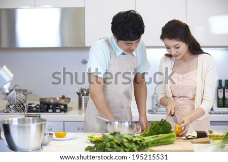 the image of a happy Asian family cooking