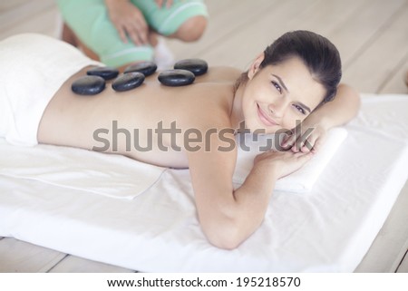 Asian woman having hot stone treatment