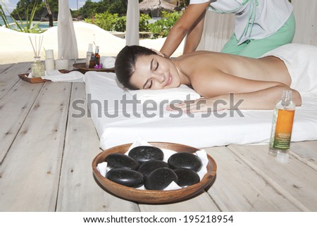 Asian woman getting a hot stone massage
