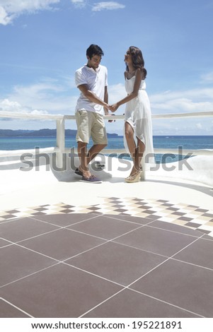 the image of Asian couple holding hands by the sea in Boracay in Philippines
