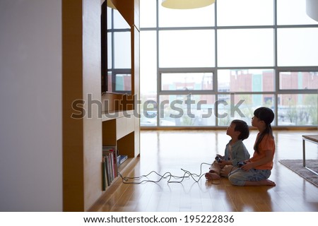 the image of a happy Asian kids playing video games