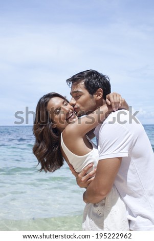 Asian couple by the sea in Boracay in the Philippines