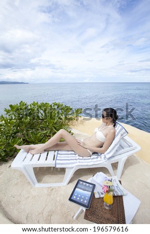 Woman sun bathing in Boracay in Philippines