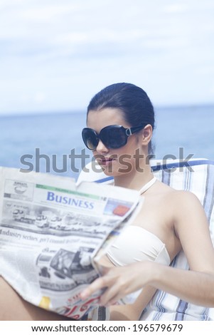 Woman on vacation reading paper, Boracay in Philippines
