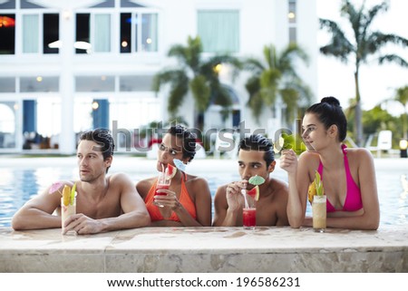people enjoying swimming pool in resort