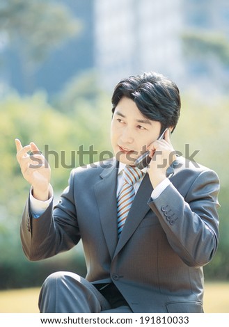 The image of Korean business man on phone
