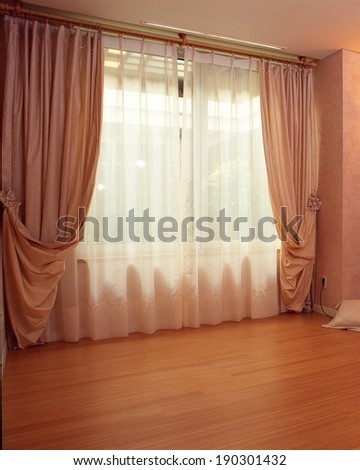 The depiction of living room with lighting through curtain