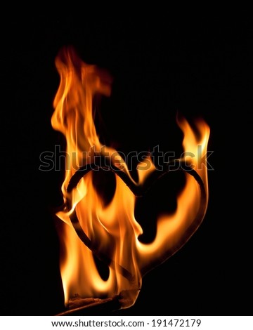 Fire flames burning around a heart wire