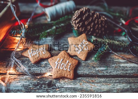 Christmas mood still life on a vintage background with pine cones, Happy holidays gingerbread cookies and lights