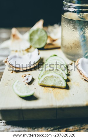 refreshing chilled coconut water with lime wedges