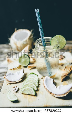 refreshing chilled coconut water with lime wedges