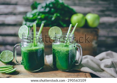 Green smoothie on a wooden background