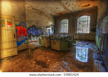old laboratory with a puddle and graffiti