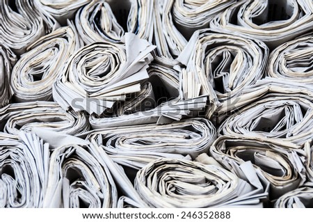 background of lots of rolls of newspapers