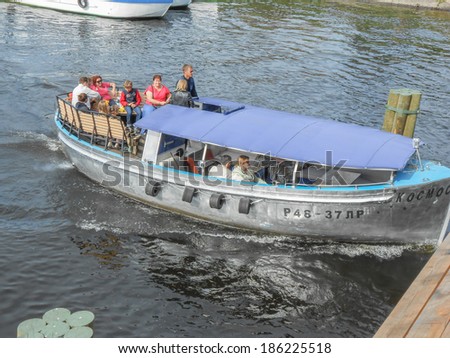 SAINT PETERSBURG, RUSSIA - AUGUST 31, 2013: Tourists  on a boat over river Neva visiting the city of Saint Petersburg aka Leningrad in Russia